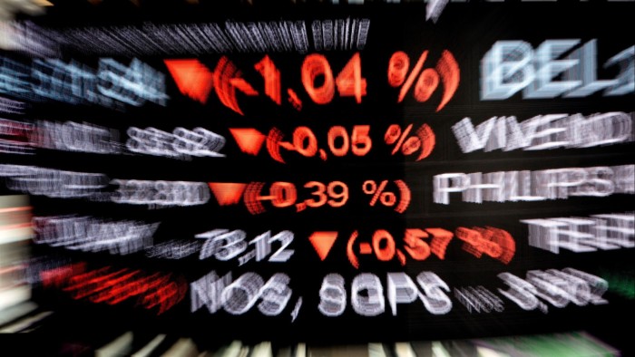 Price movements are displayed on a digital screen hanging inside the Euronext NV Paris stock exchange